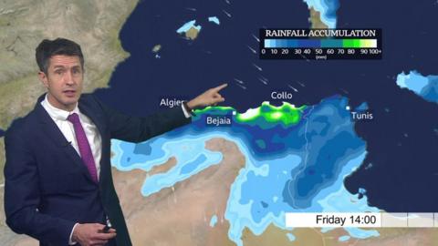 Chris Fawkes standing in front of a weather map of north Africa