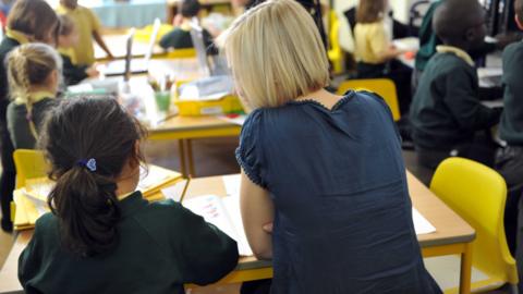 Teacher and a girl in a classroom