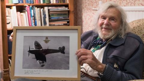 Dr Edmund James with Spitfire photograph