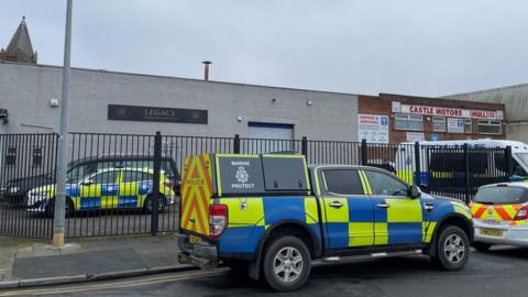 Police vehicles outside funeral directors home