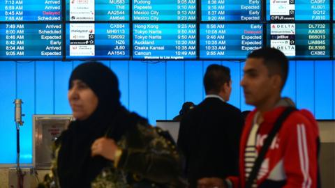 People arrive at the international terminal of Los Angeles International Airport on 8 February 2017