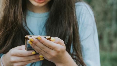 Woman looking through smartphone