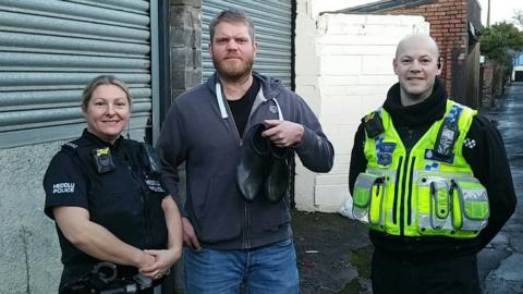 Rob Davies (centre) who found the shoes with PC Alex Reed and PC Stephen Westlake