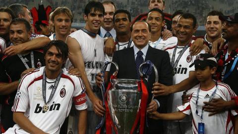 AC Milan owner Silvio Berlusconi holds the Champions League trophy with players following victory in the final in 2007