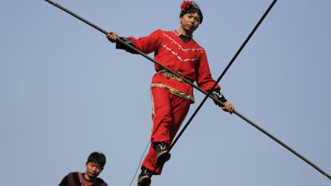 Acrobats perform on a tightrope in Beijing