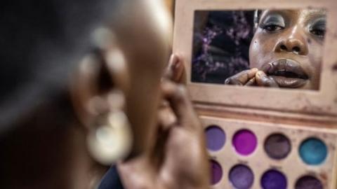 A model gets her make up done before the main fashion show during the Kibera Fashion Week in the informal settlement of Kibera in Nairobi, on October 15, 2023. Kibera Fashion Week is a platform created from the community to redefine fashion and creativity while showcasing beauty and talent as a way to change the narrative about Nairobi's largest informal settlement.