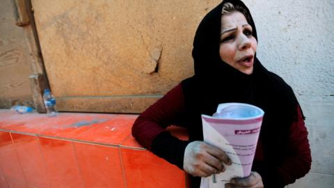 A woman reacts after a fire kills 12 babies at the Yarmouk Hospital in Baghdad (10 August 2016)