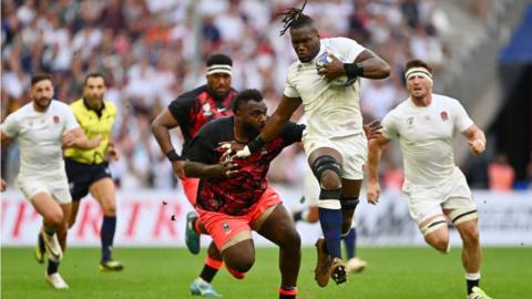 England's Maro Itoje breaks through the tackle of Fiji's Luke Tagi