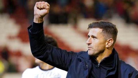 Pompey head coach John Mousinho pumps his fist after a League One win.