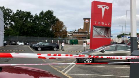 Police tape at Tesla dealership