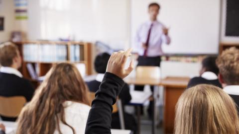 A teacher seen teaching a class