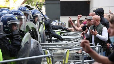 Police are confronted by protesters in Whitehall near Parliament Square