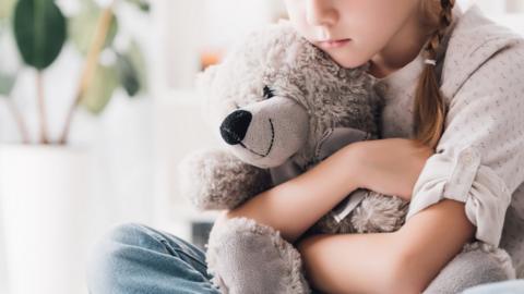 girl-holding-teddy-bear.