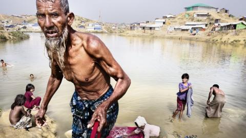 A man comes out of bathing in a river