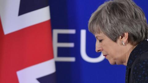 British Prime Minister Theresa May walks away after holding a press conference in Brussels on March 22, 2019