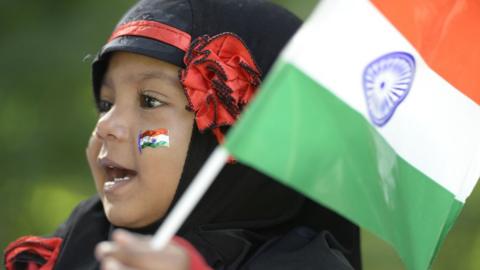 An Indian girl holds the flag during India's Independence Day celebrations