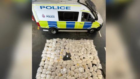 Police van next to heroin and ketamine seized after raiding a lorry