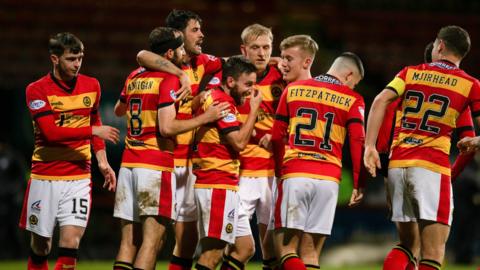 Steven Lawless is crowded by his team-mates after scoring the winner