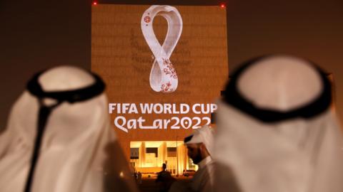 The Qatar World Cup logo projected onto a building