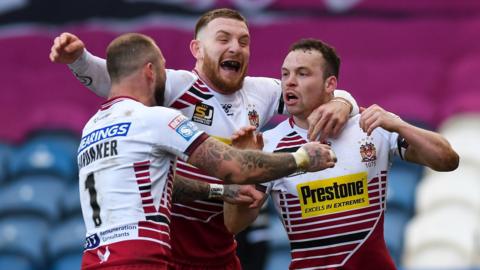 Liam Marshall's hat-trick at the John Smith's Stadium included two in Wigan's burst of three in six minutes just before the break