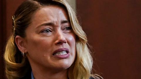 Amber Heard cries during court testimony on Wednesday