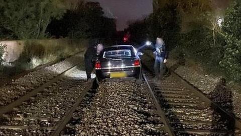 Car on railway line