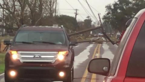 An electricity cable is torn down amid extreme weather in Louisiana