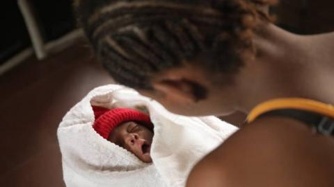 Woman looking at a baby