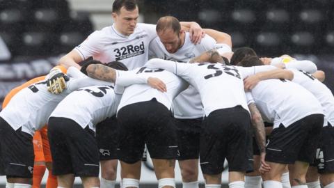 Derby County players in a huddle before their Championship match against Sheffield Wednesday