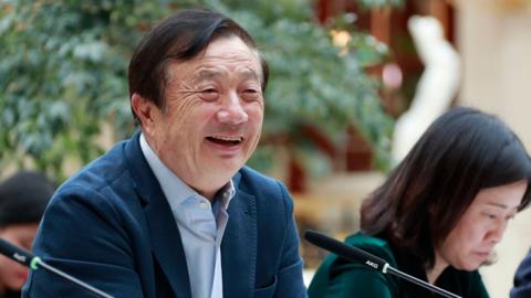 Huawei founder Ren Zhengfei (L) speaking to Chinese media in Shenzhen