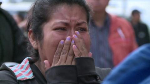 Woman reacts to earthquake damage
