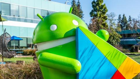 A large green statue of the green Android mascot is seen outside the company's Mountain View headquarters