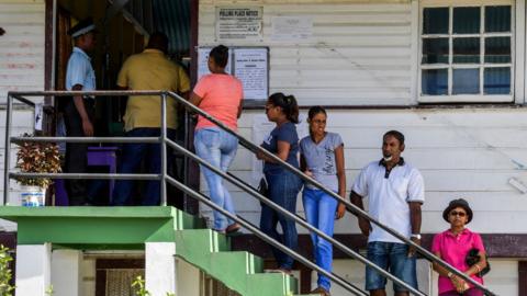 Guyanese citizens line up to vote, in Leonora, Guyana on 2 March