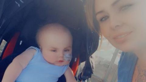 Drae pictured in a pram next to his mum