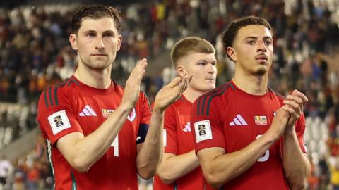 Wales captain Ben Davies, Jordan James and Ethan Ampadu applaud fans