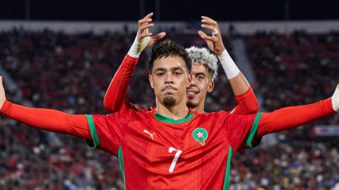 A picture of Morocco's Othmane Maamma celebrating with team-mate Yassir Zabiri