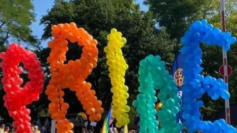 Balloons spelling out Pride at Pride in Surrey event 