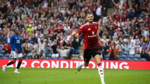 Joe Hugill celebrates scoring for Manchester United at Glasgow Rangers