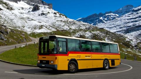 A bus driving up a mountain.