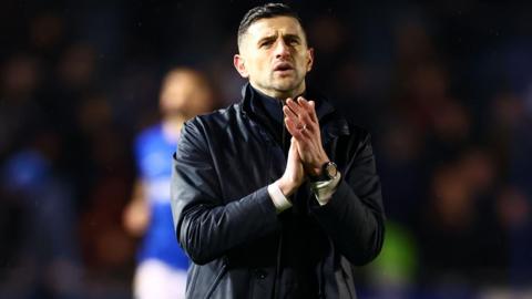 Portsmouth manager John Mousinho claps the fans after the 4-0 win over Swansea at Fratton Park