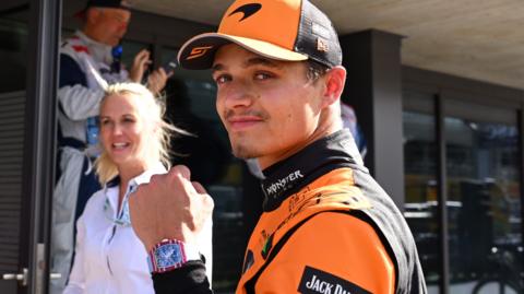 Lando Norris clenches his left fist in celebration and looks at the camera after taking pole position for the Austrian Grand Prix