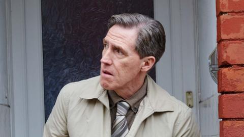 Uncle Bryn stood outside his front door