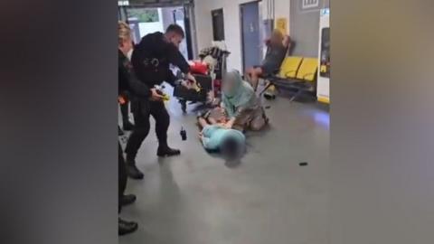 A police officer was recorded kicking a man, who is lying face down on the floor