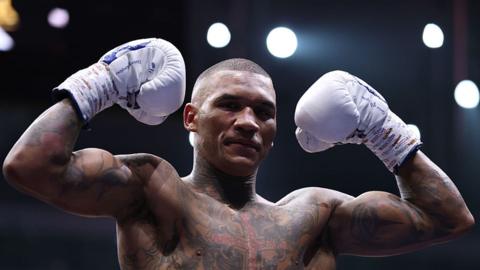 Conor Benn holds up his gloves