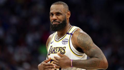 LeBron James holds his hands on his chest