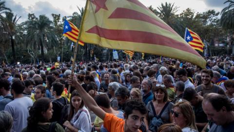 People gather to hear Catalan President Carles Puigdemont speak on October 10, 2017 in Barcelona