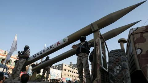 Palestinian militants from Hamas's military wing, the Izzedine al-Qassam Brigades, display a Qassam rocket at a parade in Rafah, southern Gaza, on 21 August 2016