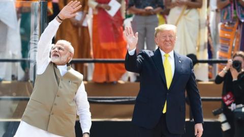 Narendra Modi and Donald Trump wave to the crowd