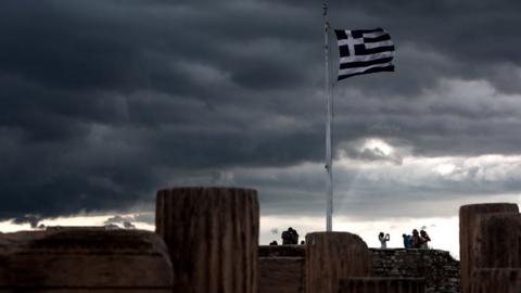 A Greek flag waves in the breeze at Acropolis hill, in Athens on 5 June 2015