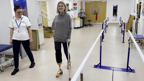 Sarah de Lagarde using a stick to walk during rehabilitation.